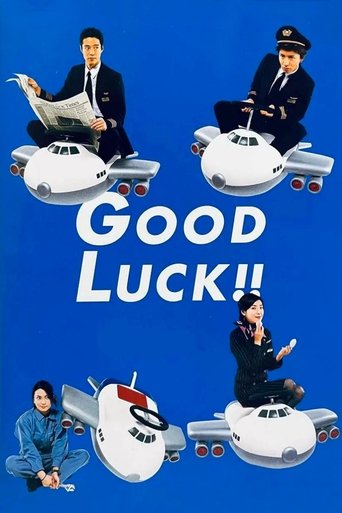 The poster features four characters in formal attire—men in suits and a woman in a uniform—each seated on a miniature airplane against a vibrant blue background. The title "GOOD LUCK!!" is prominently displayed in bold white letters, evoking a cheerful, adventurous tone. The overall composition s...