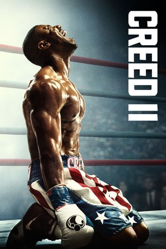 The muscular man in a red and white striped shirt kneels on the boxing ring, looking up with a determined expression. The poster features bold white text "CREED II" on the right side. The mood is intense and powerful, capturing the spirit of the film.