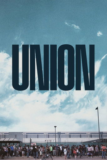 The poster features a large crowd of people gathered in front of a modern building under a bright blue sky. The bold, dark text "UNION" dominates the upper portion, creating a striking visual impact. The overall mood is one of unity and community, evoking a sense of collective strength and purpose.