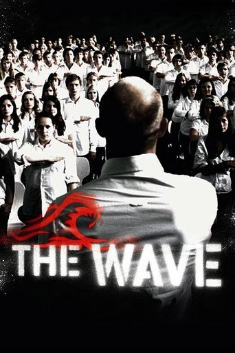 This movie poster features a bald man in a white shirt standing with his back to the viewer, surrounded by a large crowd of people. The image is predominantly black and white, with a striking red wave design at the bottom. The mood is mysterious and dramatic, suggesting a thriller or drama.