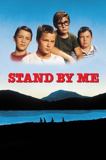 The poster features four young boys in a serene lakeside setting, with the title "STAND BY ME" prominently displayed in bold red letters. The image evokes a nostalgic, slightly melancholic mood, capturing the essence of their childhood memories.