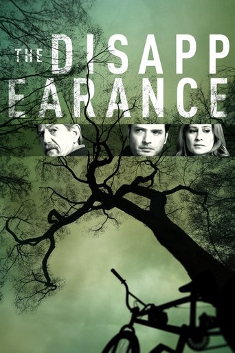 The poster features three faces against a hauntingly green background, evoking a spooky atmosphere. A gnarled tree dominates the scene, with a bicycle leaning against it, suggesting a mysterious or supernatural setting. The title "The Disappearance" is prominently displayed in bold, distressed le...