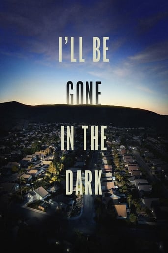 The poster features a serene night scene with a town at dusk, bathed in warm golden hues against a deep blue sky. Silhouettes of people are faintly visible in the distance, adding a sense of mystery and solitude. The title, "I'll Be Gone in the Dark," is prominently displayed in bold, white lette...