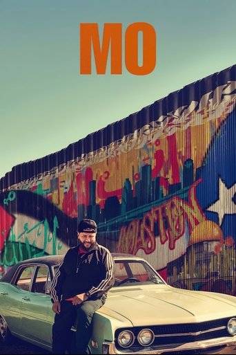 The poster features a man in a dark jacket and hat standing confidently beside a vintage car, with a colorful graffiti-covered wall behind him. The warm, nostalgic tones and the bold orange "MO" text evoke a sense of urban grit and artistic expression.