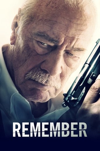 An elderly man with a mustache holds a gun, his intense gaze directed forward. The poster features a dark blue background with the title "REMEMBER" in bold white letters. The mood is somber and serious.