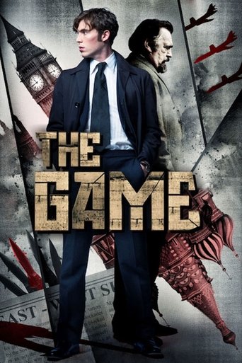 The poster features two young men in formal attire against a gritty, dark background. The title "THE GAME" is prominently displayed in bold, metallic letters. A large clock and a rifle are visible in the background, suggesting themes of suspense and danger. The overall mood is tense and mysteriou...