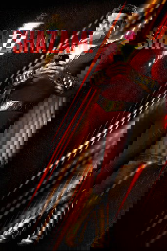 The poster features Shazam in a heroic pose, wearing a red and gold suit with a white cape. The background is dark with glowing red and gold streaks, creating a dramatic and intense mood. The title "SHAZAM!" is prominently displayed in bold red letters.