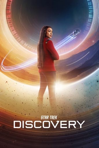 The poster features a young woman in a red jacket standing confidently against a cosmic backdrop of swirling galaxies and vibrant hues. The warm tones of her outfit contrast with the cool blues and purples of the space behind her, creating a dynamic visual. The title "Star Trek: Discovery" is pro...