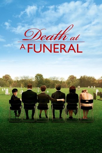 The poster depicts a somber funeral scene with six mourners seated in chairs facing away from the camera, their backs turned to the viewer. The image is dominated by a serene blue sky with scattered clouds, contrasting with the dark green grass and the solemn black chairs. The title "Death at a F...