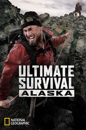 A rugged survivalist in a red jacket and helmet stands amidst rocky terrain, exuding determination. The poster features bold white text against a muted natural backdrop, evoking a sense of adventure and resilience. The National Geographic logo subtly anchors the image, suggesting an authentic exp...