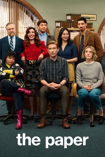 The poster features a group of eight characters in a warm, inviting office setting with wooden desks and bookshelves. The characters are dressed in a mix of casual and semi-formal attire, reflecting their personalities. The muted tones of the room—soft browns, greens, and grays—create a cozy atmo...