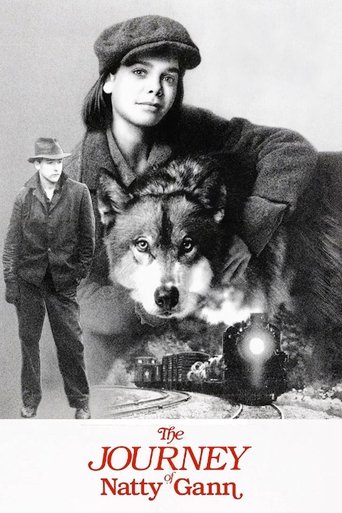 This black-and-white poster features a young girl with a large wolf beside her, exuding a sense of adventure and camaraderie. The title, "The Journey of Natty Gann," is prominently displayed in bold red letters at the bottom, suggesting a classic film with timeless appeal.