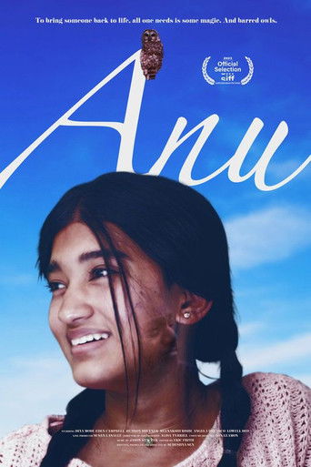The poster features a young woman with dark hair and a gentle smile against a bright blue sky, evoking a sense of hope and innocence. The title "Anu" is elegantly written in white script, while a small film logo sits at the top. The overall mood is warm and uplifting, suggesting a story of person...