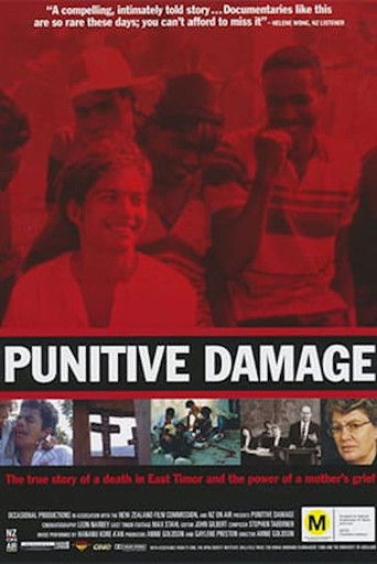 The poster features a dark, ominous red background with silhouettes of people in various poses, evoking a sense of danger and tragedy. The title "PUNITIVE DAMAGE" is prominently displayed in bold white letters, emphasizing the film's intense and disturbing theme. The overall mood is one of suspen...