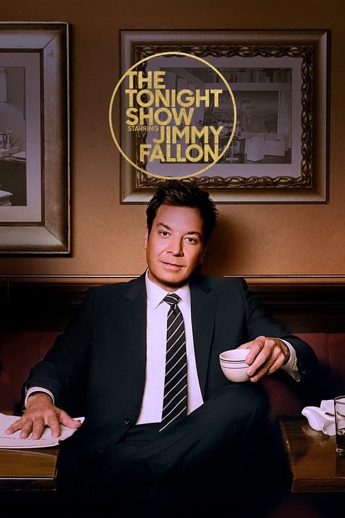 The image features Jimmy Fallon in a sharp suit against a warm, inviting backdrop. The poster emphasizes his relaxed yet professional demeanor, with a soft, golden glow surrounding the show's title. The muted tones of the room and the warm lighting create an intimate and cozy atmosphere, reflecti...