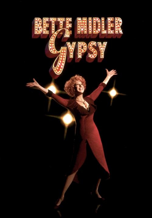 The poster features a glamorous woman in a red dress with arms raised, surrounded by sparkling lights against a black background. The title "Gypsy" is displayed in bold, glittering letters, evoking a sense of exotic allure and romance.