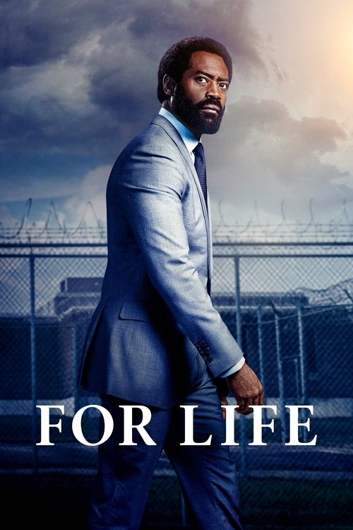 A man in a light blue suit walks confidently against a backdrop of a prison fence, with the words "FOR LIFE" prominently displayed. The dramatic sky adds to the serious, hopeful tone of the poster.