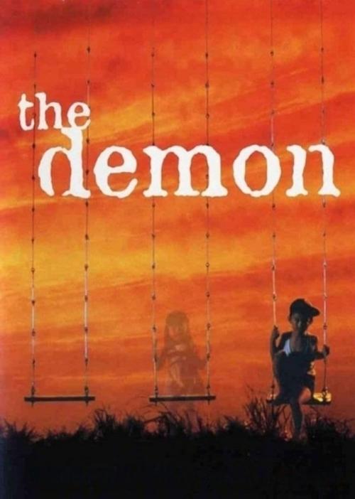 The movie poster features a silhouette of a man holding a lantern against a vibrant sunset sky. A ghostly figure floats in the distance, adding an eerie atmosphere. The title "the demon" is prominently displayed in bold white letters, evoking mystery and suspense.