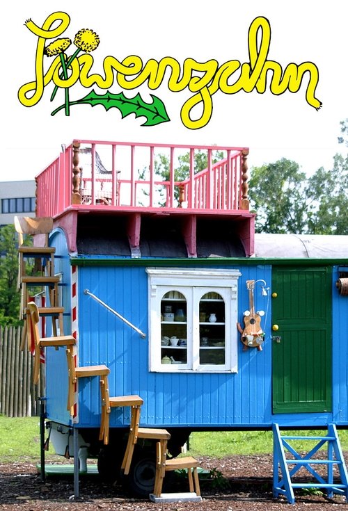 The poster features a whimsical blue house with a red balcony, set against a sunny backdrop. A cheerful green "Löwenzahn" logo glows above, suggesting a playful, friendly tone. The scene evokes a sense of nostalgia and joy, capturing the charm of a classic children's television show.
