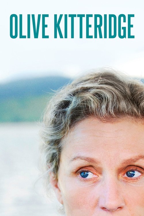 The poster features a close-up of Olive Kitteridge's expressive face with her eyes wide open, set against a serene backdrop of soft hills and water. The muted tones of her skin and hair, combined with the calm, natural colors, evoke a sense of introspection and quiet contemplation.