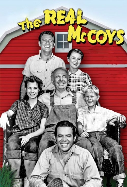 This vintage-style poster features a group of smiling McCoys in a red barn setting, exuding warmth and nostalgia. The black-and-white photograph captures their joyful expressions against a cheerful backdrop, evoking a classic sitcom charm.
