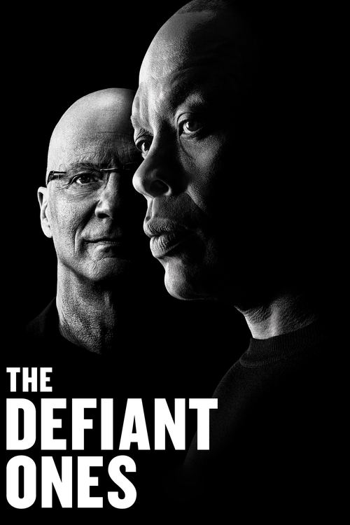 The poster features two men in a dramatic black-and-white portrait against a dark background. The title "THE DEFIANT ONES" is prominently displayed in bold white letters. The mood is intense and mysterious, suggesting a story of resistance or defiance.