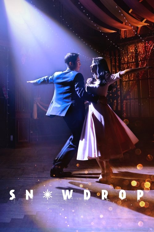 A couple dances in a dimly lit theater, illuminated by dramatic spotlights. The man wears a bright blue suit, while the woman sports a flowing red dress. The poster captures a romantic, intimate moment with soft bokeh lights in the background.