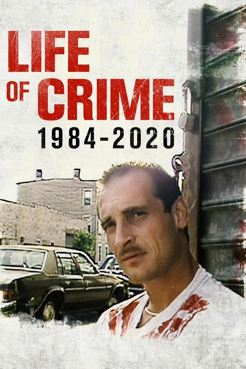 The poster features a gritty, urban scene with a man in a white shirt stained with blood, exuding a somber and intense mood. The title "Life of Crime: 1984-2020" is prominently displayed in bold red letters against a textured, weathered background. The image evokes a sense of danger and historica...