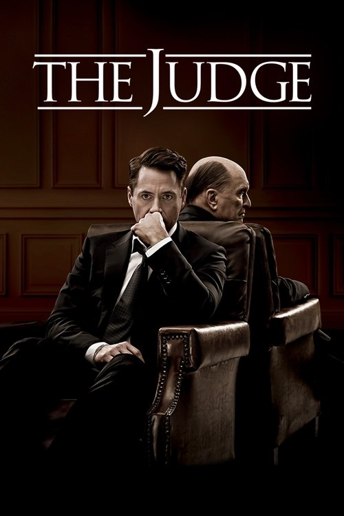The movie poster features two men in formal suits, one seated and one standing, set against a dark, moody background with warm lighting. The title "THE JUDGE" is prominently displayed at the top in bold, serif font. The overall mood is serious and dramatic, suggesting a courtroom drama.