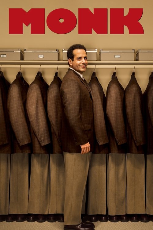 A man in a brown suit stands confidently in front of a rack of brown suits, with the bold red "MONK" logo prominently displayed above. The warm lighting and earthy tones evoke a classic, timeless atmosphere.