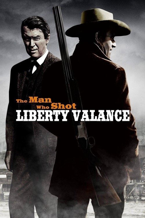 The poster features two men in a dramatic, moody atmosphere. One man in a dark suit stands on the left, while the other, wearing a cowboy hat and coat, holds a shotgun. The title "The Man Who Shot Liberty Valance" is prominently displayed in bold, white letters. The overall mood is intense and su...