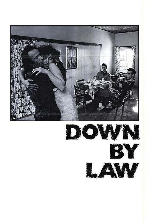 The poster features a black-and-white scene of a couple embracing warmly in a modestly furnished room, with a band playing in the background. The mood is intimate and nostalgic, capturing a moment of connection amidst everyday life.