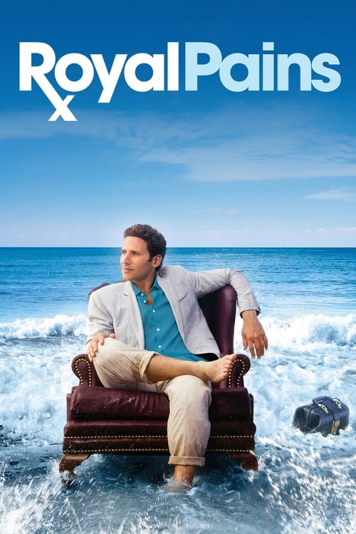 The poster features a man in a white suit and blue shirt sitting on a wooden chair amidst crashing waves, evoking a sense of adventure and humor. The vibrant blue sky and ocean backdrop enhance the lively and energetic mood of the show.