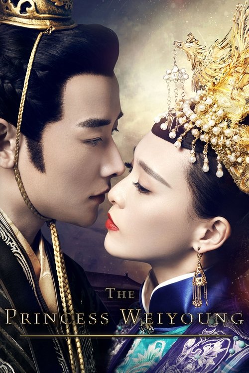 The poster features a tender, close-up shot of a man and woman in an intimate embrace, their faces nearly touching. The man wears ornate golden jewelry, while the woman dons a regal crown and flowing blue robes. The warm, golden lighting enhances the romantic and dramatic atmosphere, suggesting a...