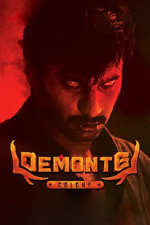 The poster features a dark, shadowy man with intense eyes, set against a dramatic red background. The title "Demonte Colony" glows in fiery orange hues, evoking a sense of mystery and danger.
