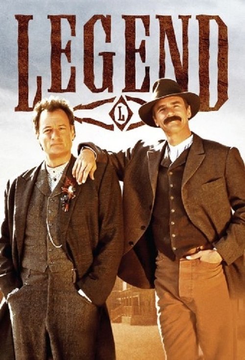 The poster features two men in 19th-century Western attire against a dusty, sunlit backdrop. The title "LEGEND" dominates the top in bold, weathered lettering, evoking a rugged, historical atmosphere. The warm tones and confident poses suggest a thrilling, adventurous story.