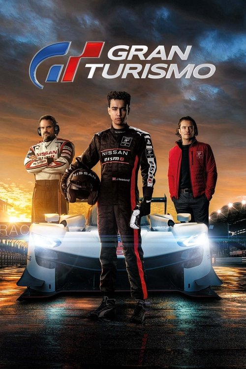 The poster features three characters in racing gear against a dramatic sunset backdrop. The central figure holds a helmet, while the others stand beside him, exuding confidence. Vibrant colors like reds, blacks, and oranges dominate the scene, creating an intense and thrilling atmosphere. The sle...