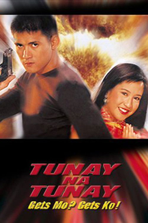 The poster features a dynamic scene with a man in a black shirt and a woman in a red outfit, both looking determined. The background is filled with fiery explosions, suggesting action and danger. The bold red text "TUNAY NA TUNAY" dominates the bottom, emphasizing the title. The overall mood is i...