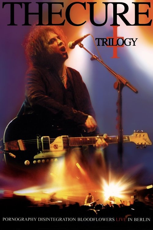 The Cure's iconic band members are captured in a dramatic concert scene, with one guitarist passionately playing an electric guitar while another sings into a microphone. The poster features a fiery background, symbolizing the band's psychedelic rock energy and vibrant atmosphere. The overall moo...
