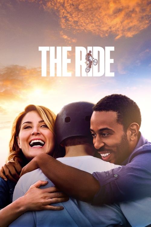 The poster features a heartwarming scene of two men embracing warmly against a vibrant sunset backdrop. The warm orange and yellow hues create a joyful atmosphere, while the title "THE RIDE" is prominently displayed in bold white letters.