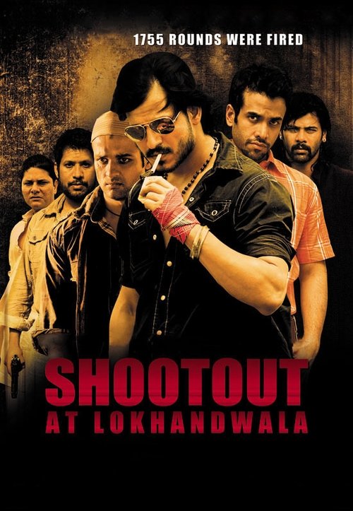The poster features a gritty, intense scene with a central actor in a black shirt holding a microphone, surrounded by other men in various outfits. The warm, dramatic lighting and bold red text convey a serious, action-packed atmosphere.