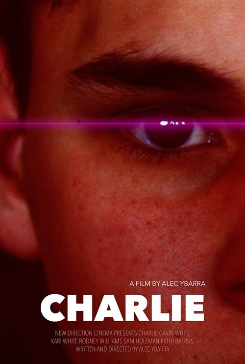 The poster features a close-up of a young man's face, with a piercing purple iris piercing through the eye. The warm, reddish tones evoke a sense of mystery and intensity, while the bold white title "CHARLIE" stands out against the dark background.