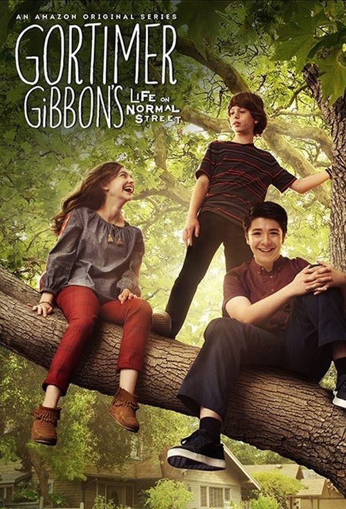 The poster features three characters in a vibrant outdoor setting with lush greenery and warm sunlight. The girl on the left wears red pants and a gray top, while the boy in the middle sports a striped shirt and dark pants. The man on the right is dressed in a maroon shirt and dark pants. The ove...