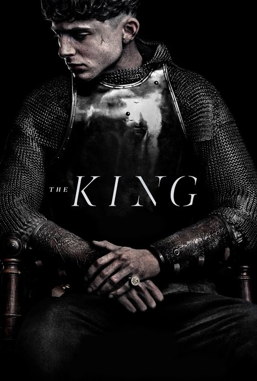 The poster features a rugged man in dark, chainmail armor, exuding an air of mystery and power. The title "THE KING" is prominently displayed in bold, white letters against a dark background. The overall mood is intense and dramatic, with a focus on the man's intense gaze and the gritty, textured...