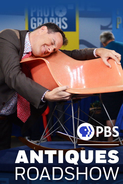 A man in a suit and tie leans over a vibrant orange chair, appearing to be in distress or exhaustion. The PBS logo and "Antiques Roadshow" text are prominently displayed at the bottom. The scene captures a humorous and unexpected moment, blending humor with the show's quirky atmosphere.
