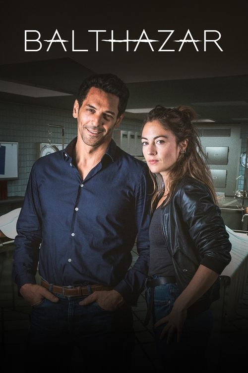 The poster features a man and woman in dimly lit, moody lighting with warm tones. The man in a dark shirt and the woman in a leather jacket stand close together, exuding a sense of mystery and intrigue. The title "Balthazar" is prominently displayed at the top, suggesting a dramatic or supernatur...