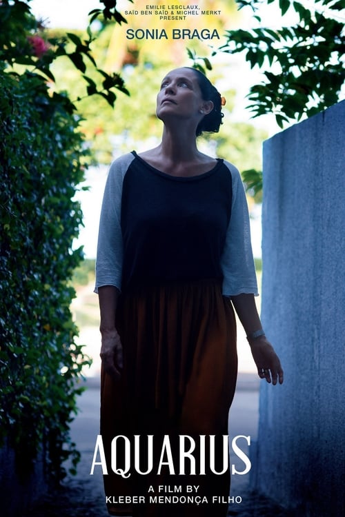 The poster features a woman in a black top and brown skirt, gazing upward with a serene expression. She stands against a backdrop of lush greenery and a textured wall, evoking a sense of calm and introspection. The title "Aquarius" is prominently displayed at the bottom, suggesting themes of myst...