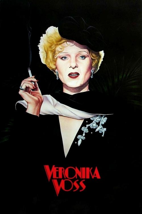 The poster features a glamorous woman with blonde hair and a black hat, holding a cigarette. The dark background contrasts with her striking appearance, creating a mysterious and dramatic mood. The red text "VERONIKA VOSS" stands out against the dark backdrop.