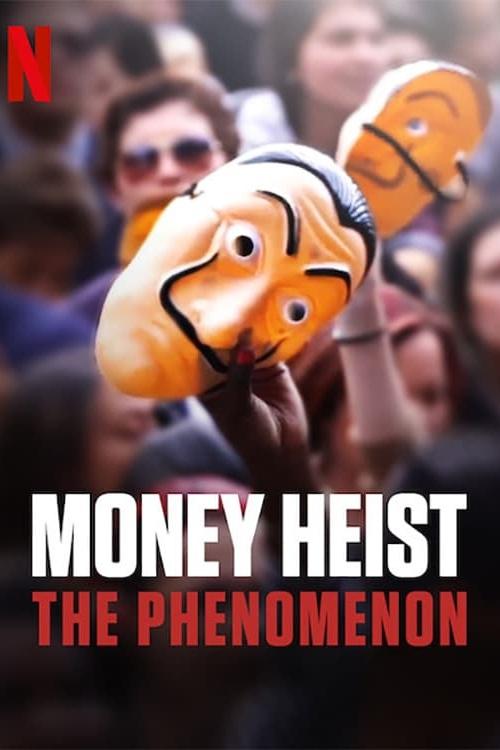 The poster features a chaotic crowd of people, some wearing sunglasses, holding up a fish-shaped mask with a menacing expression. The bold red and white text "MONEY HEIST: THE PHENOMENON" dominates the bottom, conveying a sense of mystery and intrigue.