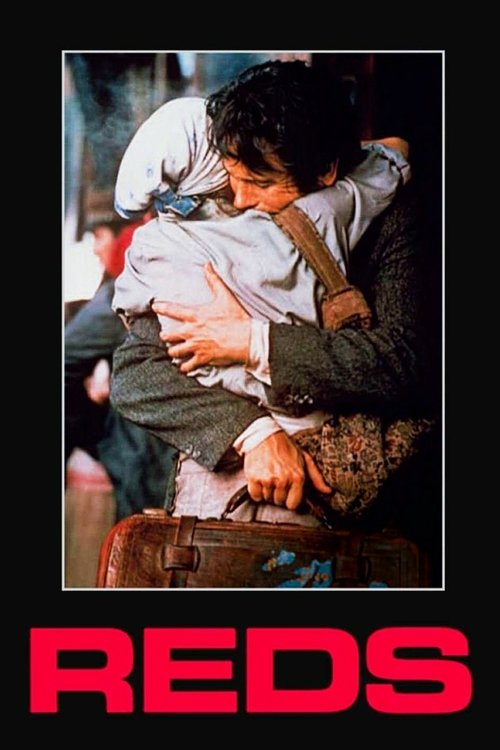 The poster captures a heartwarming embrace between two men, one in a dark suit and the other in a light-colored shirt, set against a blurred background of warm tones. The bold red text "REDS" at the bottom emphasizes the film's vibrant and emotional theme.